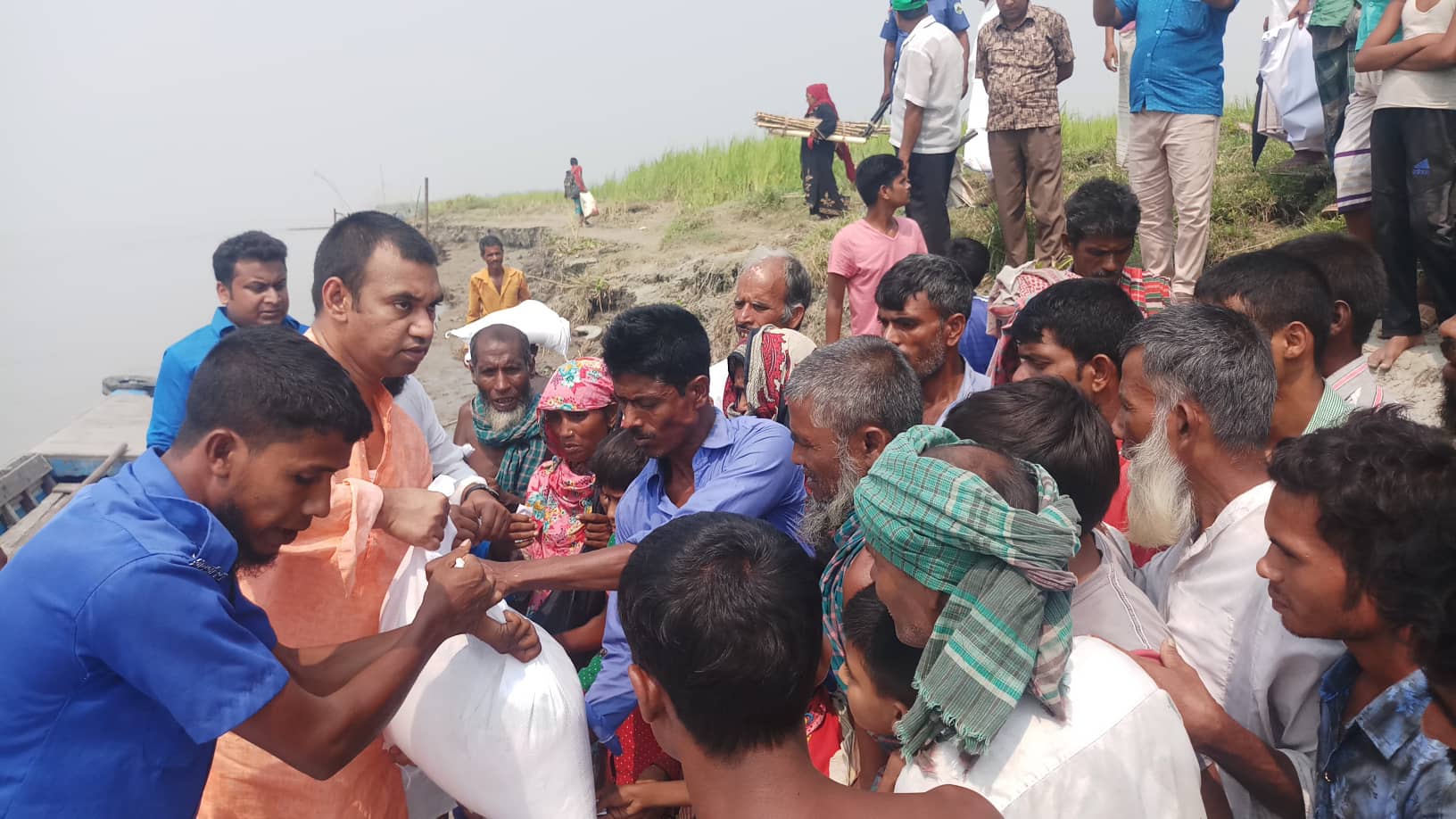 Relief supplies being distributed to families affected by river erosion