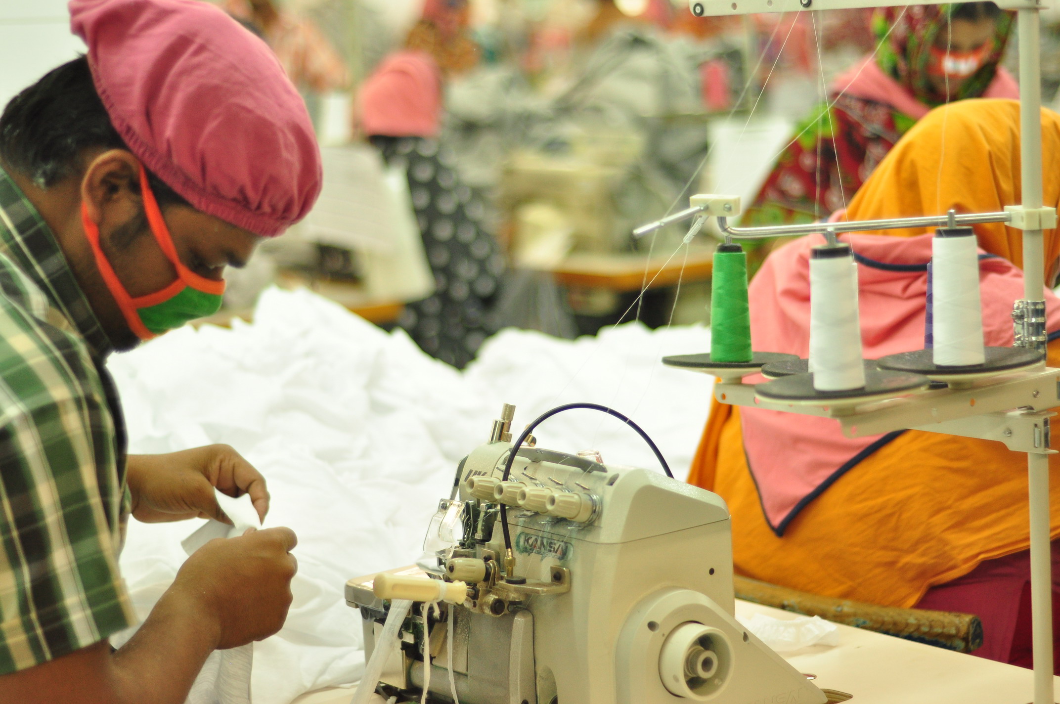 Workers sewing on an industrial production line