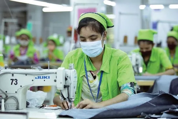Textile factory worker operating a sewing machine at a Mondol Group facility