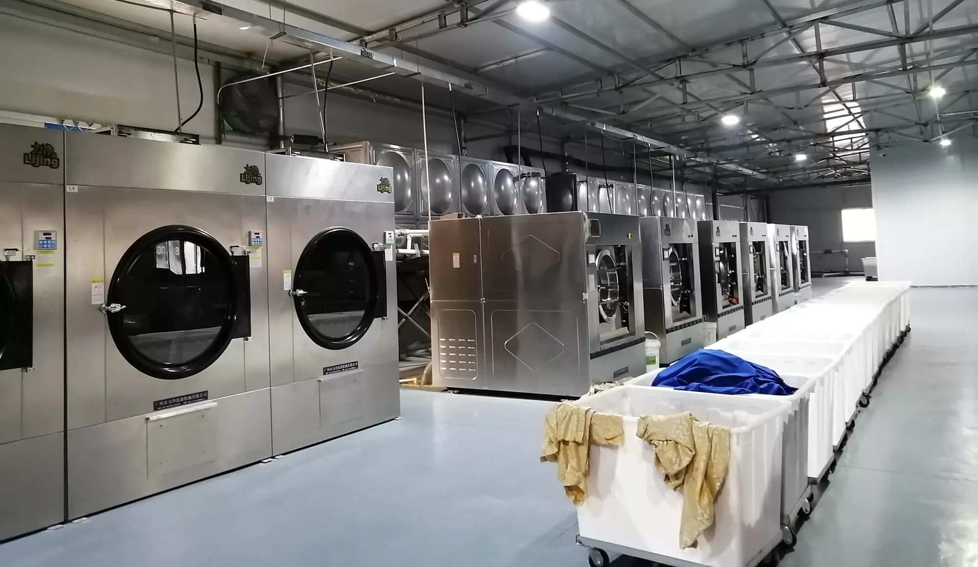 Factory workers folding finished fabric after washing and finishing